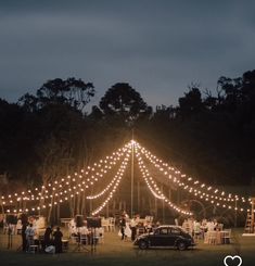 a car parked in front of a tent with lights on it