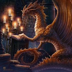 a dragon sitting on top of a table next to a book and some lit candles