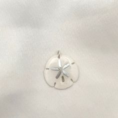 Legend has it that finding a sand dollar during a beach stroll is considered a lucky omen. So take a little bit of the beach and good luck with you wherever you go with our gorgeous Sand Dollar Charm. Real sand dollars are preserved and painted by hand in our MA studio sand dollars measure approximately 3/4 in to 1 inch. sterling silver or 14kt gold fill jump ring Sand Dollars, Sand Dollar, Jump Rings, 14kt Gold, Good Luck, 1 Inch, Gold Filled, The Beach, Take That