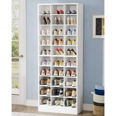 a white shoe rack filled with lots of shoes