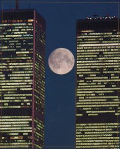 two tall buildings with the moon in the sky