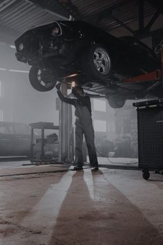 a man working on a car in a garage