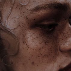 a woman with freckles on her face