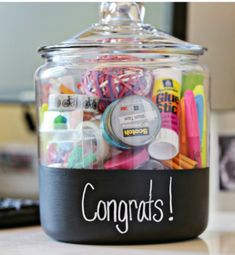 a glass jar filled with lots of different types of pens and markers