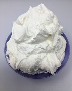 a blue plate topped with whipped cream on top of a table