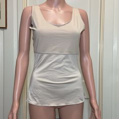 Large Light Beige Spanx By Sara Blakely Sleeveless Shapeware Tank Size: L Chest: 90% Polyester 10% Spandex / Elastane Body: 79% Polyester 21% Spandex / Elastane About 22” Long Armpit To Armpit (Bust): 16” Arm Hole Width: 7” Waist: 13" Bottom Hem Width: 16" No Stains, Tears Or Holes At All Excellent As Nwot Condition Clean And Smoke Free Home Quick Shipping- All Items Are Shipped Daily As Long As Usps Is Open. Make Me Offers! Message Me With Any Questions! You Like More Than One Item In My Closet Beige Bra Friendly Sleeveless Camisole, Sleeveless Stretch Shapewear With Medium Bust Support, Sleeveless Shapewear With Medium Bust Support, Summer Shaping Tops With Built-in Bra, Summer Tops With Built-in Bra And Shaping, Fitted Tank Strap Shapewear Tops, Fitted Shapewear Tops With Tank Straps, Fitted Shapewear Tank Top, Summer Shapewear Cami Tops