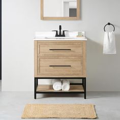 a bathroom with a sink, mirror and rug on the floor in front of it