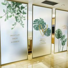 three glass doors with plants painted on them