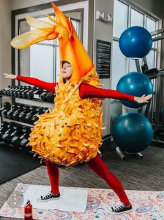 a woman in a yellow dress is doing exercises