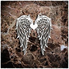 two black and white angel wings on a marble background with the word love written in it