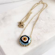 Introducing our stunning Cable Chain with a Hand-Painted 19mm Evil Eye Turkish Pendant in a Decorative Prong Setting. This gold Evil Eye Necklace is the perfect addition to any jewelry collection, with its unique design and intricate detailing. Crafted with care, this necklace features an 18+2 inch chain and a hand-painted Turkish pendant measuring 19mm in size. The evil eye symbol is said to ward off negative energy and bring good luck, making this necklace both beautiful and meaningful. Our Ca Gold Evil Eye Necklace, Ward Off Negative Energy, Evil Eye Symbol, Evil Eye Necklace Gold, Eye Symbol, Bring Good Luck, Hand Painted Ceramic, The Evil Eye, Evil Eye Necklace