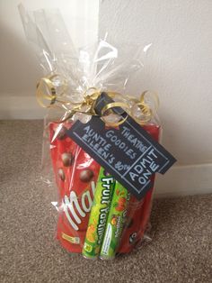 a bag filled with candy and snacks sitting on the floor