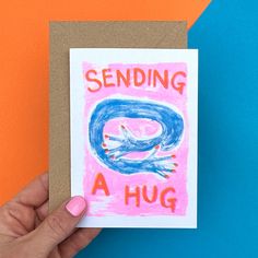 someone holding up a card that says sending a hug