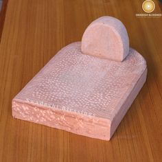 a pink object sitting on top of a wooden table