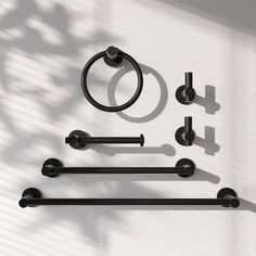 an assortment of black hardware on a white wall