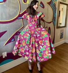 "Oh HELLO to this beauty of a dress! Original 1980's 'echo' 100% cotton pink bright floral stunner with allllll the trimmings; yoke waist, ruffle neckline, FULL circle skirt, pockets. It's a winner, y'all. In excellent condition, this is 80's-does-50's the right way.  Bust: best for 34\" and under  Waist: 28\" max, works well on 25-27\"  Hips: free Model is 5'7\" and 115 lbs with 30\" bust, 24\" waist, 34\" hips. This fit well with breathing room, and was not pinned." Retro Pink Ruffled Dresses, Retro Pink Dresses With Ruffles, Pink Retro Dresses With Ruffles, Pink Retro Dress With Ruffles, 115 Lbs, Breathing Room, Peignoir Sets, Skirt Pockets, Full Circle Skirt