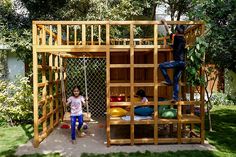 two children playing in a wooden play structure