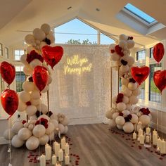 a room filled with lots of white and red balloons