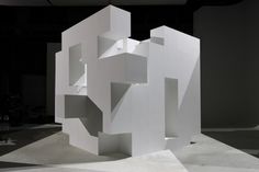 an abstract white sculpture in the middle of a room