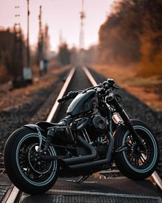 a motorcycle is parked on the train tracks