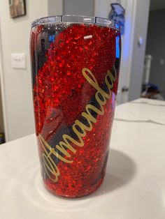 a red and black tumbler with the words arizona on it sitting on a counter