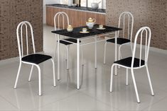 a black and white dining table with four chairs