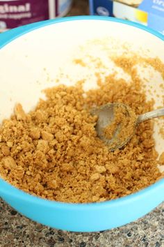 a blue bowl filled with cereal on top of a counter