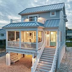 a white house with stairs leading up to it