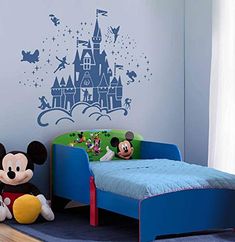 a child's bedroom with mickey mouse wall decal