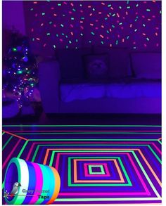 a living room filled with furniture and colorful lights on the wall above it's carpet