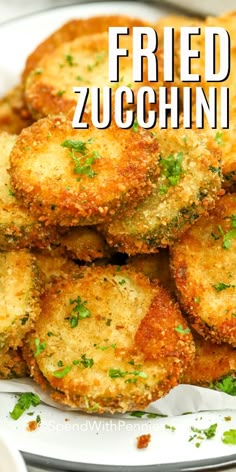 fried zucchini on a white plate with parsley in the middle and text overlay that reads fried zucchini