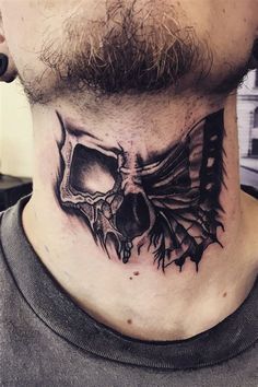 a man's neck with a skull and wings tattoo on the top of it