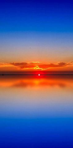 the sun is setting over the water and reflecting it's reflection in the water