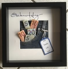 a frame with some money in it and a tag