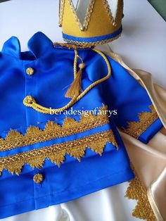 a blue and gold outfit with a crown on top