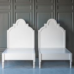 two white beds sitting next to each other