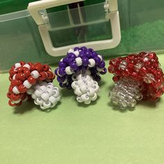 three plastic beads sitting on top of a table next to an object in the background