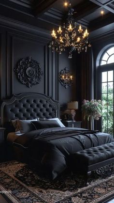 an elegant bedroom with black walls and chandelier