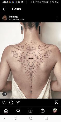 the back of a woman's neck with an intricate design on her left side