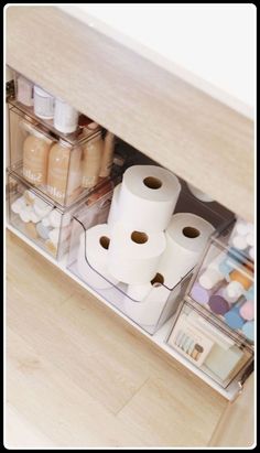 an organized drawer with toilet paper and other items