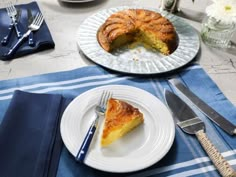 a piece of pie on a plate next to a knife and fork with another slice missing