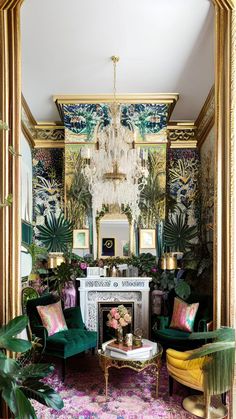 a living room filled with green furniture and lots of greenery on the wall behind it