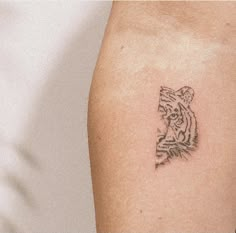 a small tiger tattoo on the left thigh