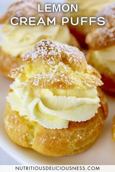 lemon cream puffs on a plate with powdered sugar