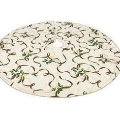 a white and brown tree skirt with green leaves on the bottom, in front of a white background