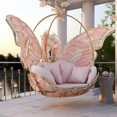 a butterfly shaped chair sitting on top of a balcony