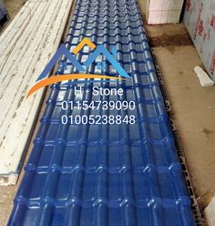 an image of a conveyor belt with blue plastic sheets on it in a warehouse