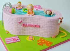 a cake that is shaped like a pool with people in it and on the side