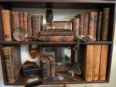 an old book shelf filled with books and other items