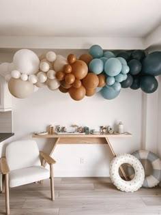 balloons are hanging on the wall above a table